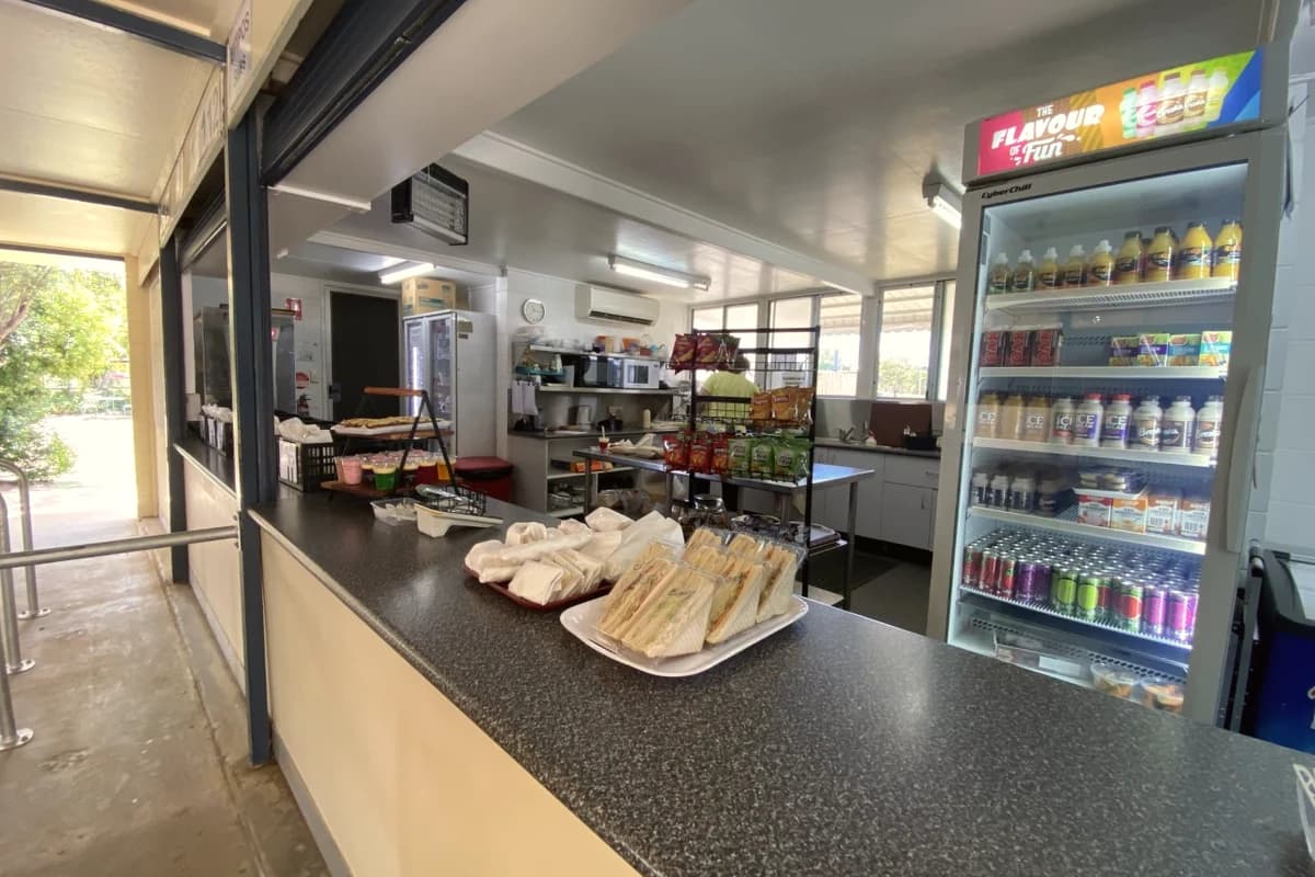 Students buying snacks at a busy school canteen counter